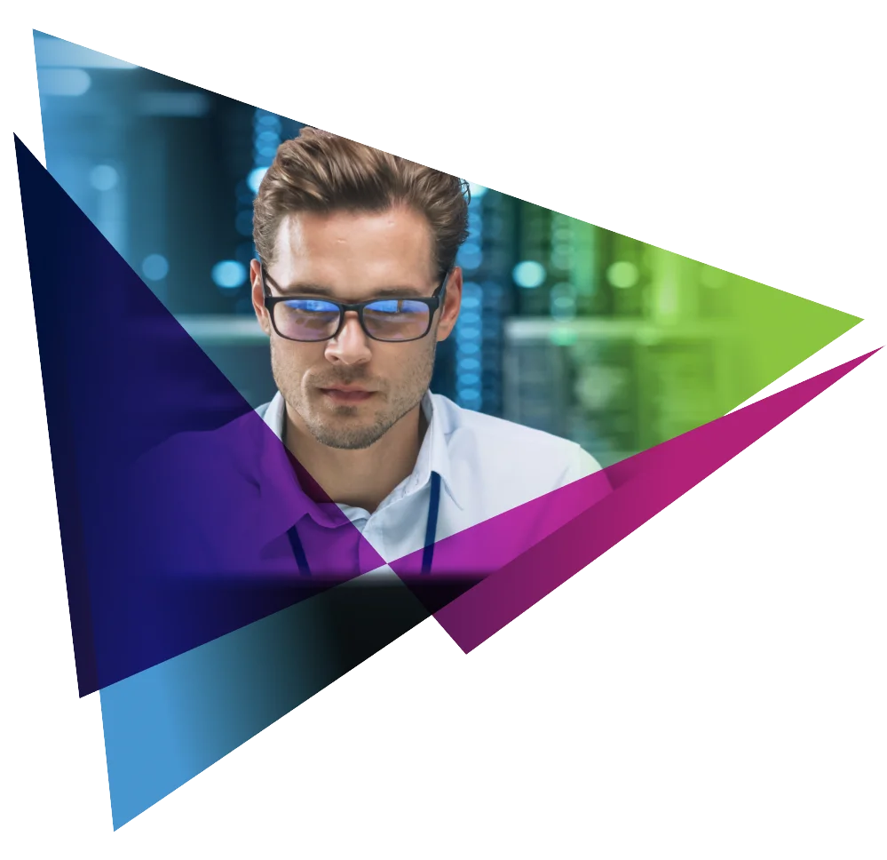 Professional in glasses working with data servers, overlaid with colorful geometric shapes.